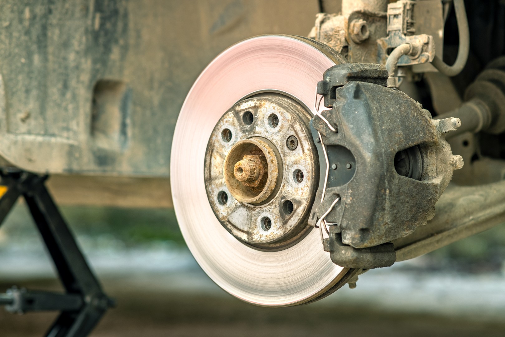 Closeup of braking disc of the vehicle with brake caliper for re